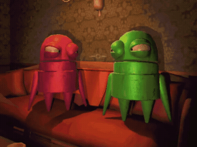 Green And Red Robots Sitting On Couch GIF