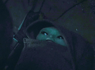 Green Baby With Beard Looking Up In Dark GIF