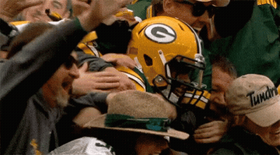 Green Bay Packers Player Surrounded By Fans With G Helmet GIF