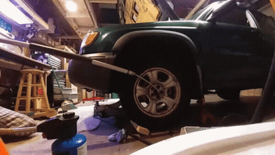 Green Car Being Repaired In Garage GIF