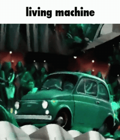 Green Car In Front Of Crowd Saying Living Machine GIF