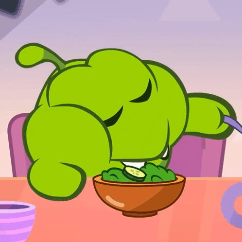 Green Cartoon Character Sitting At Table With Bowl Of Food GIF