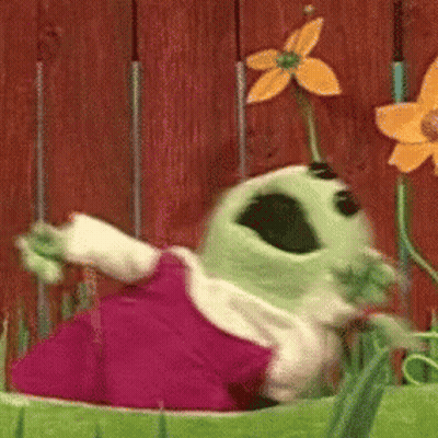 Green Cartoon Character With Flower Dancing In Garden GIF