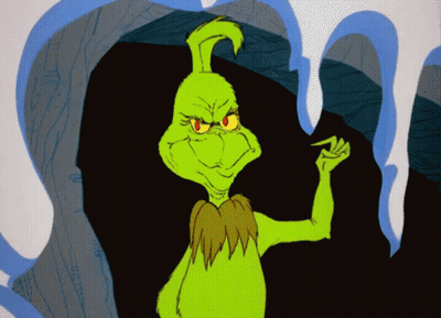 Green Cartoon Character With Red Eyes Standing In Front Of Cave GIF