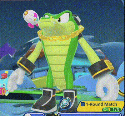 Green Cartoon Holding Balloon In Mouth GIF