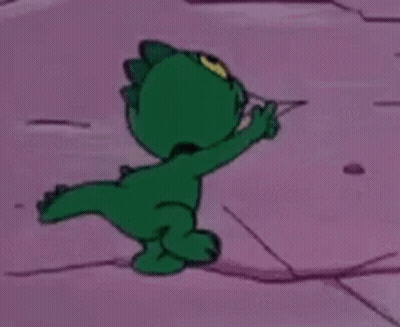 Green Cartoon Pointing On Pink Surface GIF
