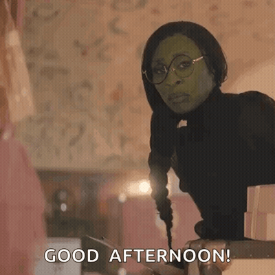 Green Costumed Woman With Glasses On Suitcase Good Afternoon GIF