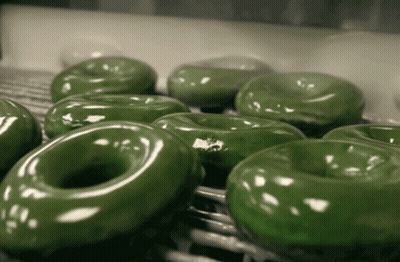 Green Donuts Sitting On A Shelf GIF
