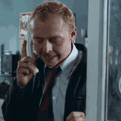 Green Frog In Pink Bow Tie Looking At Camera GIF