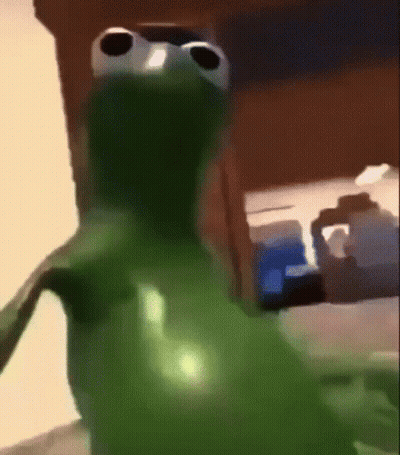 Green Frog With Big Eyes Standing in Front of Table