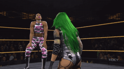 Green-Haired Female Wrestler Blowing Pink Bubble Gum GIF