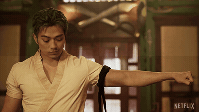 Green-Haired Man Standing In Front Of Netflix Ad GIF