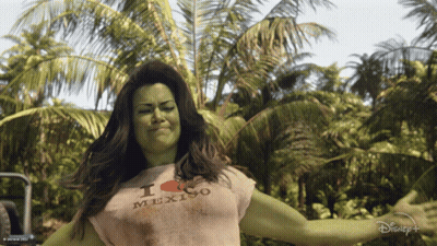Green-Haired Woman In White Shirt Raising Arm GIF