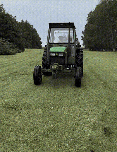 Green John Deere Tractor Driving Through Field GIF