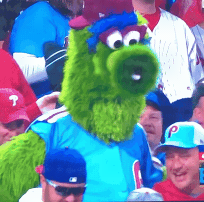 Green Mascot In Blue Shirt With Letter P GIF