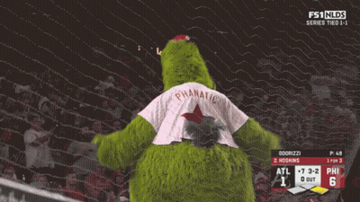 Green Mascot In Phanatic Jersey Standing By Net GIF