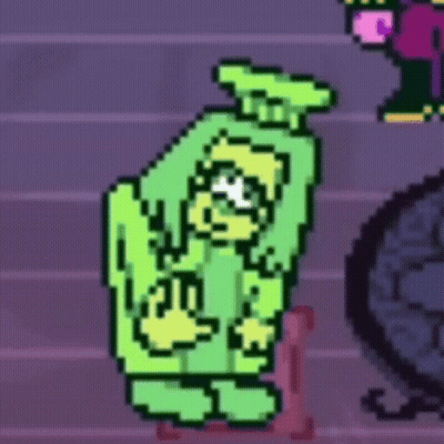 Green Monster Standing Next To Pink Chair GIF
