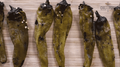 Green Peppers On Wooden Board With Chili Logo GIF