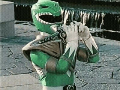 Green Power Ranger Holding Gun On Brick Sidewalk GIF