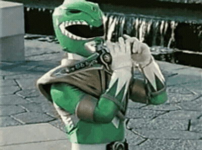 Green Power Ranger Holding Sword On Sidewalk GIF