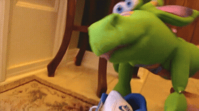 Green Puppet Playing With Blue Nike Shoes GIF