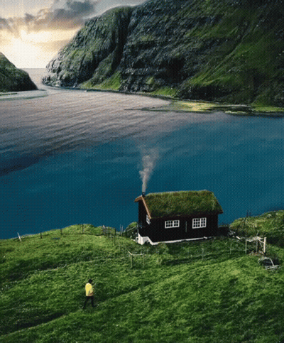 Green Roof House With Chimney Smoke In Field GIF