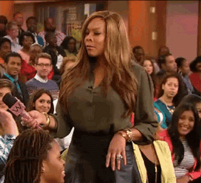Green Shirt Woman Holds Pink Mic To Crowd GIF