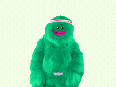 Green Stuffed Animal With Pink Headband Saying We Move GIF