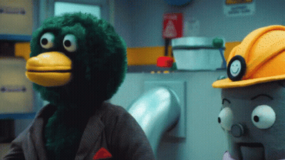 Green Stuffed Animal With Yellow Beak And Hard Hat GIF