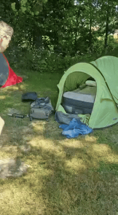 Green Tent In Grass With Suitcase GIF