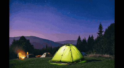 Green Tent Lit Up By Campfire At Night GIF