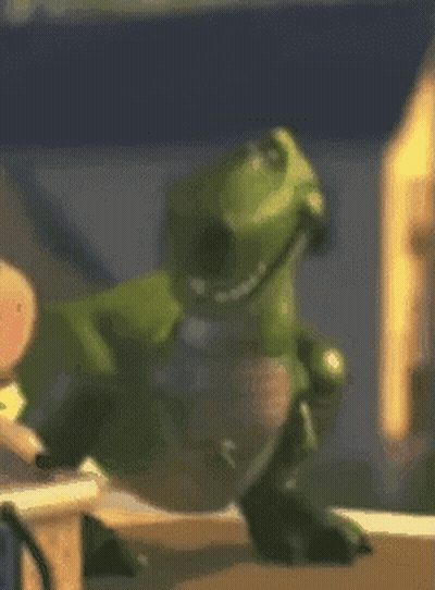 Green Toy Dinosaur Wearing Headphones GIF