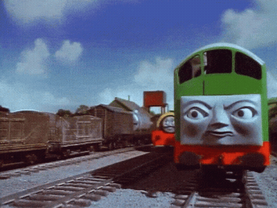 Green Train With Face On Tracks GIF