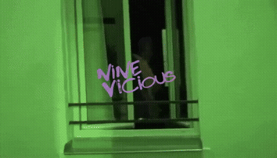 Green Wall With Purple Writing Saying Nine Vicious GIF
