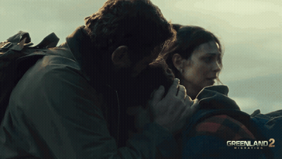 Greenland 2 Migration Movie Poster Man And Woman Hugging GIF