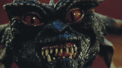 Gremlin Face With Bright Red Eyes GIF