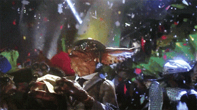 Gremlin In Suit Surrounded By Confetti GIF