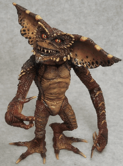 Gremlin Toy With Sharp Claws And Red Eyes GIF