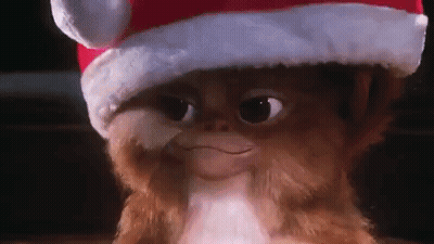 Gremlin Wearing Santa Hat Smiling GIF