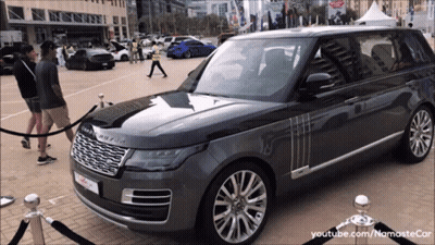 Grey Range Rover Parked With People Standing Around GIF