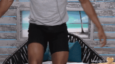 Grey Shirt Black Shorts Man Sitting On Love Island Couch GIF