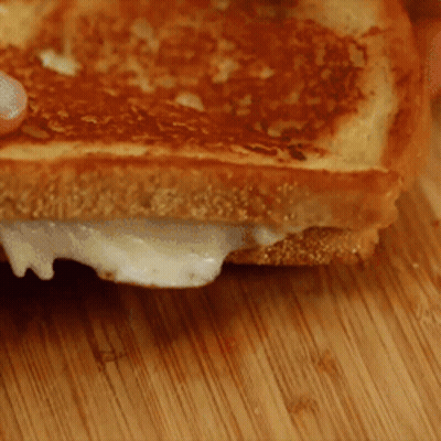 Grilled Cheese Sandwich On Cutting Board GIF