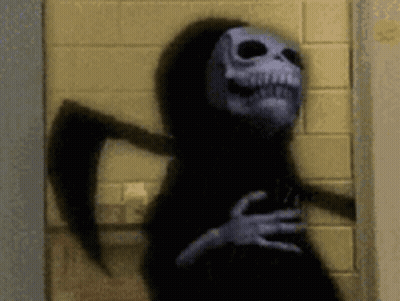 Grim Reaper With Scythe Against Brick Wall GIF