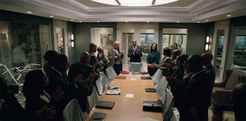Group Applauding Around Conference Table