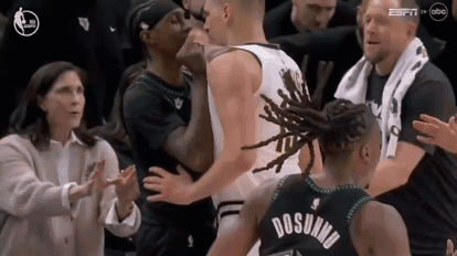 Group Around Basketball Player In Dosunmu Jersey GIF