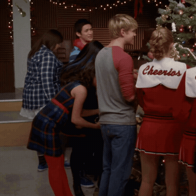 Group Around Christmas Tree Cheerleader In Cheerios Shirt GIF