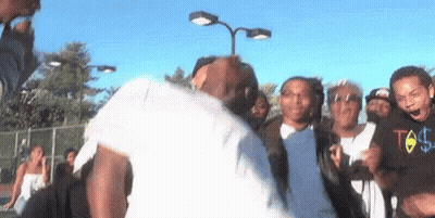 Group Around Dancing Man In White Shirt GIF