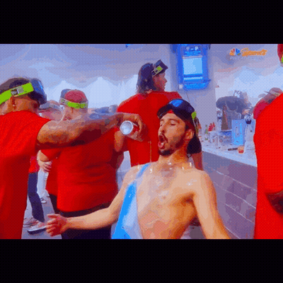 Group Around Man Drinking From NBC Can GIF