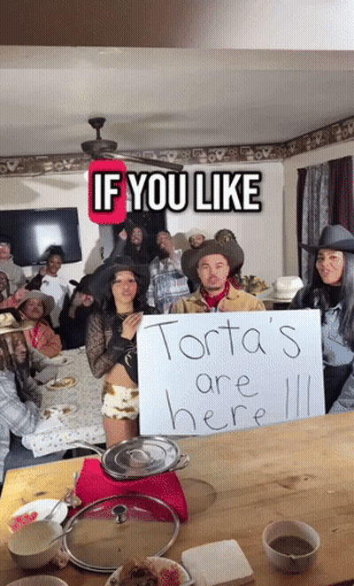 Group Around Table Saying Torta's Are Here GIF