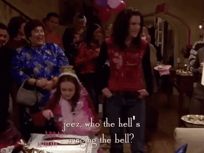 Group Around Table With Cake And Balloons GIF